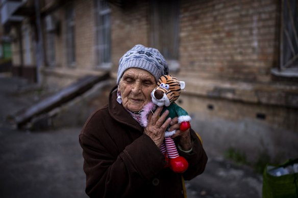 Melaniya Kovalenko, 90, hugs her cuddly toy doll given to her by an NGO as a donation, which she intends to give to her grandchildren, outside her home in Bucha. Kovalenko was born during Holodomor, lived through WWII as a teenager, and now survived Russian occupation of Bucha, "WWII and this war are different: WWII was a war, this war is a genocide against Ukrainian people." Kovalenko said.