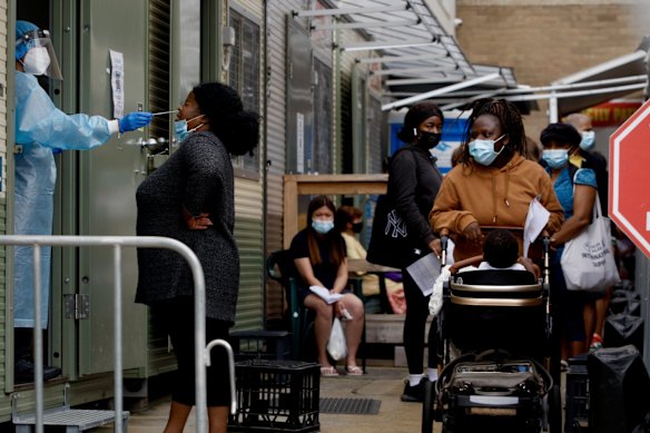 People queue at the Kildare Road Medical Centre in Blacktown for a COVID PCR test.