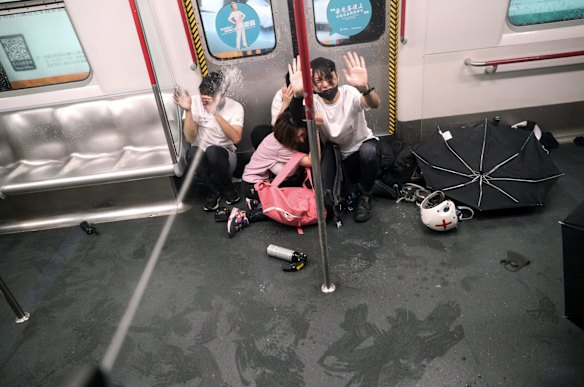 Police shoot pepper spray as they try to detain protesters inside a train at Prince Edward MTR Station, Hong Kong, Saturday, Aug. 31, 2019. 