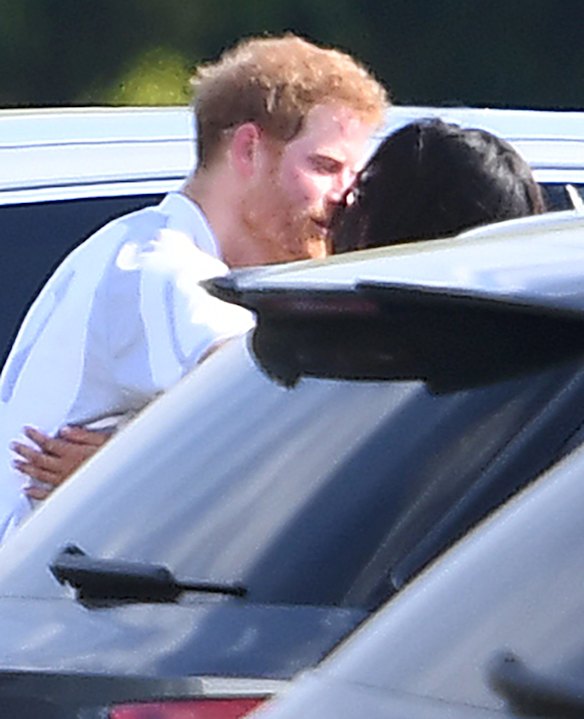 Meghan Markle and Prince Harry kiss and hug after Harry played in the Audi Polo Challenge earlier this month.