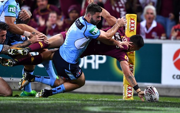 Valentine Holmes of the Maroons scores a try.