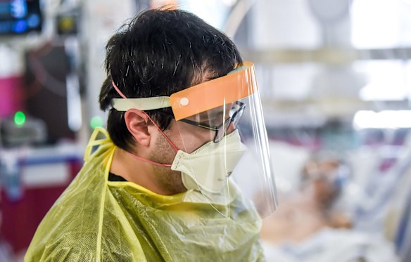 ICU nurse at work on a patient.