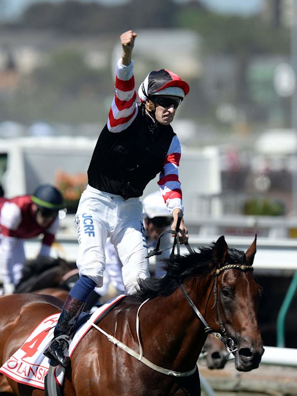 Jockey Hugh Bowman celebrates on Polanski after winning the Victoria Derby at Flemington.