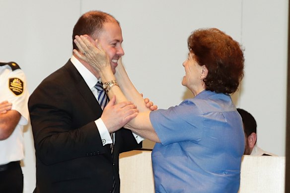 Josh Frydenberg is congratulated by long-time Parliament House cleaner Anna Jancevski after he won the position of Deputy Leader at the liberal party spill meeting