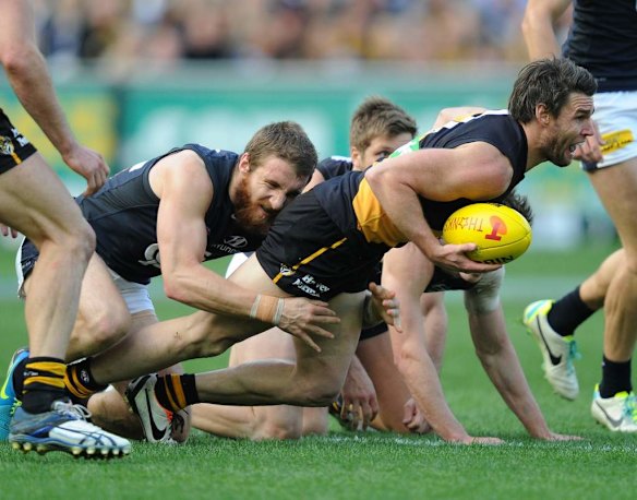Richmond's Chris Newman is tackled by Carlton's Zach Tuohy.