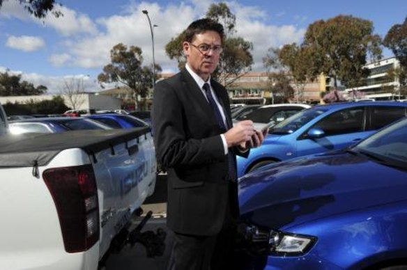 Director of Transport Regulations with ACT Justice and Community Safety, David Snowden, with one of the new hand-held devices used by parking inspectors to record infringements. 