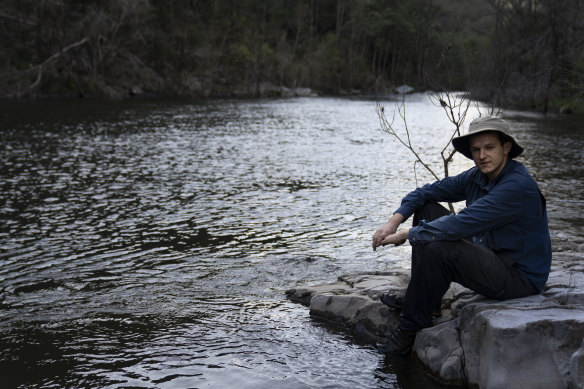 Harry Burkitt, who has led the campaign against the Warragamba Dam wall raising, sits by the Kowmung River which will be partly submerged if the project proceeds.