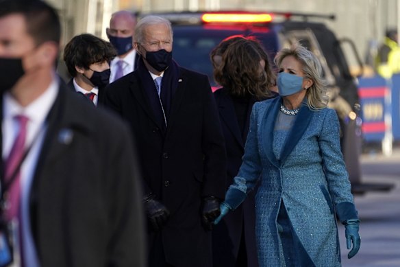 President Joe Biden walks with first lady Jill Biden during the Presidential Escort, part of Inauguration Day ceremonies, Wednesday, Jan. 20, 2021, in Washington.