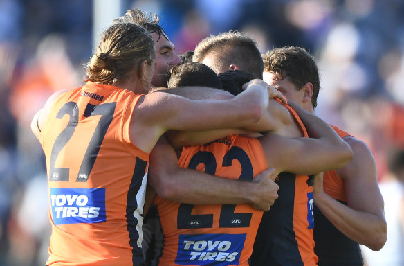 Giant leap: GWS players celebrate after Saturday's thrilling win over Geelong.