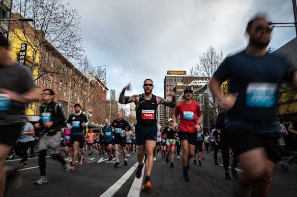 Runners head down Williams Street after the start of the fun run.