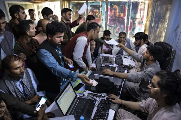 Afghan Special Immigrant Visa (SIV) applicants crowd into the Herat Kabul Internet cafe to apply for the SIV program on August 8, 2021 in Kabul, Afghanistan. Many Afghans are in desperate need of assistance completing the forms and obtaining required human resources letters, a particular challenge for those whose US government work ended years ago. The Biden administration expanded refugee eligibility for Afghans as the Taliban escalates violence in the war-torn country. Thousands of Afghans who worked for the United States government during its nearly 20-year war here now fear for their safety as the US withdraws its troops from the country. Many of these Afghans, who worked as interpreters and translators for US intelligence agencies and military branches, have applied to come to the US as part of the Special Immigrant Visa (SIV) program, with the first such group arriving in the US last month. But, for most SIV candidates, the timeline for relocation remains unknown.