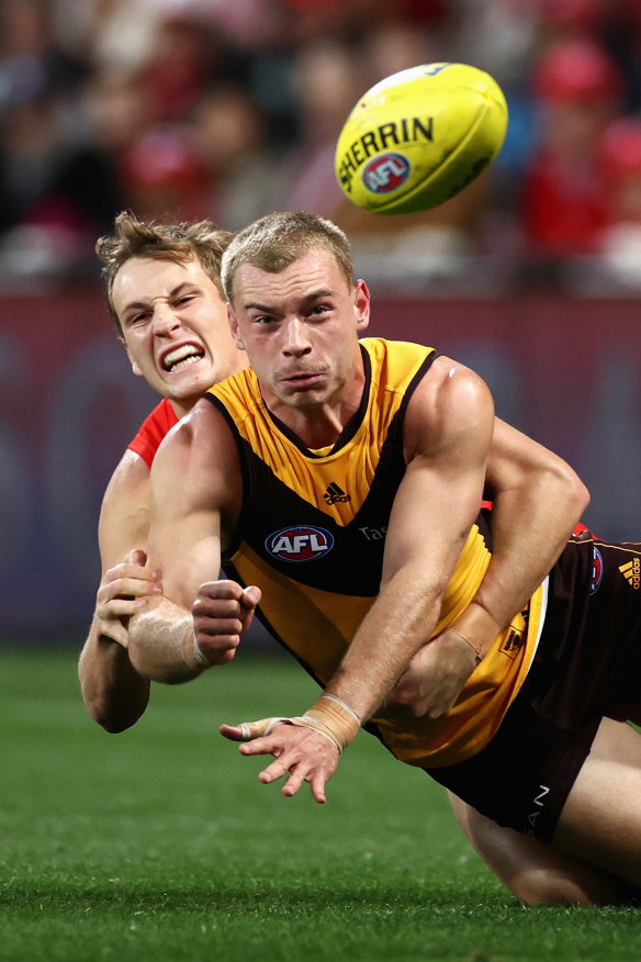 Hawthorn’s James Worpel gets a handball away.