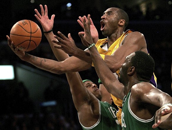 2006: Los Angeles Lakers' Kobe Bryant, top, goes up for a shot between the Boston Celtics' Paul Pierce, left, and Al Jefferson during an NBA basketball game in Los Angeles.