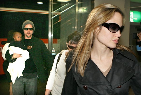 Angelina Jolie and Brad Pitt, holding their adopted child Zahara, arrive at Tokyo's international airport at Narita in 2005. 