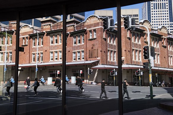 A streetscape reflected in windows of a building in the older area of Chinatown, Sydney.