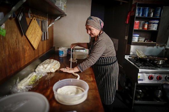 Rashida Ruzihaji prepares traditional handpulled noodles at the Tarim restaurant in Adelaide.
