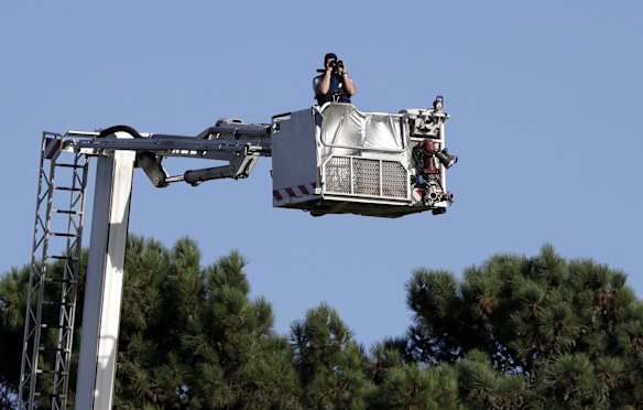 A police officer keeps watch from a cherry picker during a National Remembrance Service in Hagley Park.