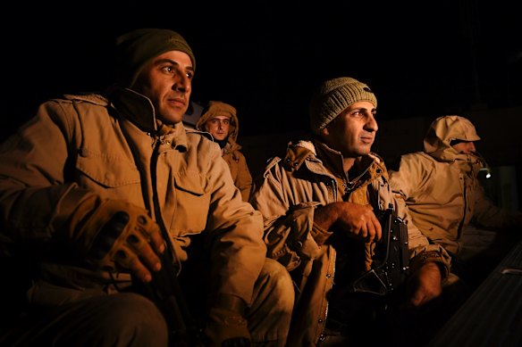 Peshmerga soldiers sit in the back of a ute waiting to start their night patrol of the Iraqi Kurdistan and Syria border looking for smugglers and refugees. Any Syrian civilian who is fleeing the war in Syria and crosses the border into Kurdiastan is taken to police and given sanctuary in Kurdistan.  According to the Kurdish government there are over 2 million refugees and IDPâs in Kurdistan from Syria and Iraq and refugees represent over 28% of the population. UNHCR statistics show that there are 251,793 registered Syrian refugees in Iraqi Kurdistan.