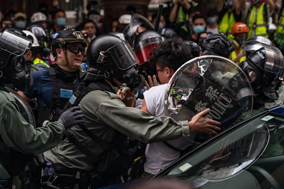 A pro-democracy supporter is detained by riot police during an anti-government rally in Hong Kong, China. 