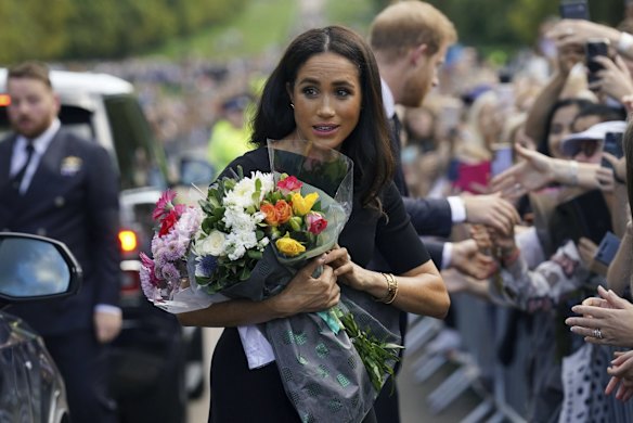 Meghan, Duchess of Sussex and Prince Harry meet members of the public at Windsor Castle.
