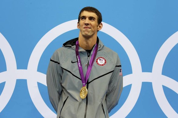 Michael Phelps of the US smiles with his gold medal during the men's 200m individual medley victory ceremony.