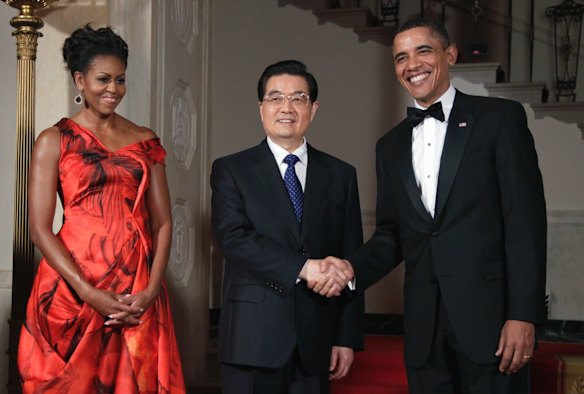 President Barack Obama and first lady Michelle Obama greet Chinese President Hu Jintao in January 2011.