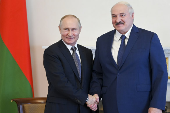 Russian President Vladimir Putin, left, and Belarusian President Alexander Lukashenko pose for a photo during their meeting in St Petersburg, Russia in July, 2021.