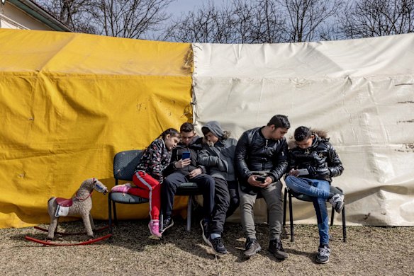 A refugee family in front of a temporary shelter in Uszka, Hungary. 