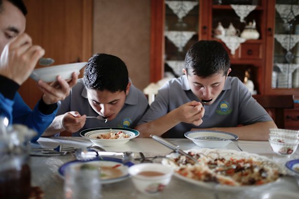 Abdullah Mu and Hamdulah Muhammad having lunch at home in Adelaide, home to about half of Australia's 3000-strong Uighur community.
