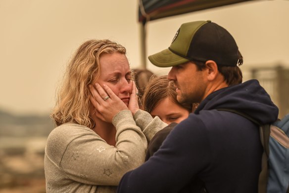 People stranded in Mallacoota after the bushfires that ravaged the town on December 30 are evacuated by army personnel to the HMAS Choules.