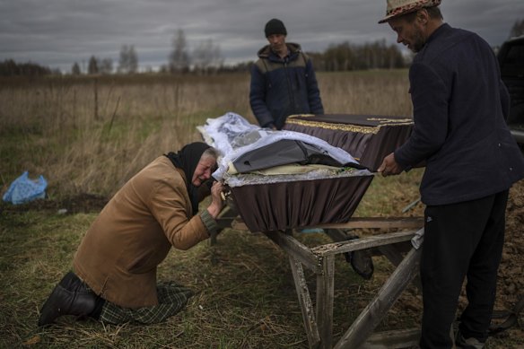 Nadiya Trubchaninova, 70, cries while holding the coffin of her son Vadym, 48, who was killed by Russian soldiers last March 30 in Bucha, during his funeral in the cemetery of Mykulychi, on the outskirts of Kyiv, Ukraine.
