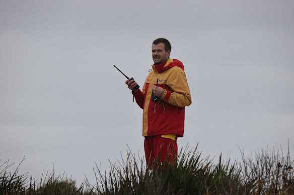Search crews look for survivors as a small aluminium boat sinks offshore in the big swell at Bondi.