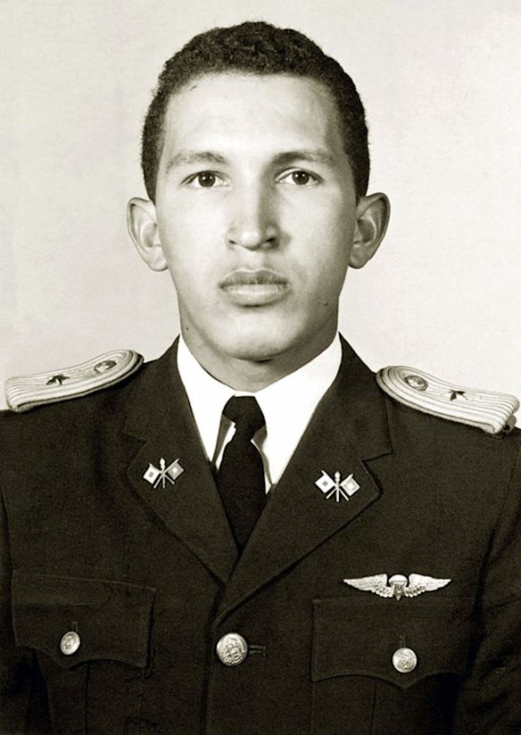 This file picture shows Venezulean President Hugo Chavez (R) before graduating as a Lieutenant from military academy in Caracas on July 5, 1975.