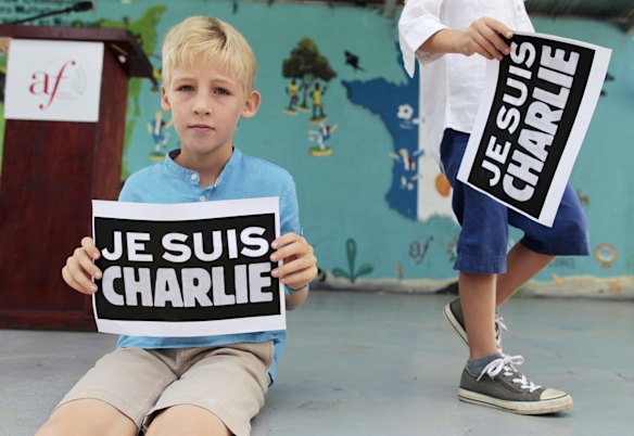 A French boy residing in Nicaragua holds up a card that reads, "I am Charlie", to pay tribute to the victims of the shootings in France at the offices of the satirical weekly newspaper Charlie Hebdo and a Jewish deli, in Managua January 10, 2015. 