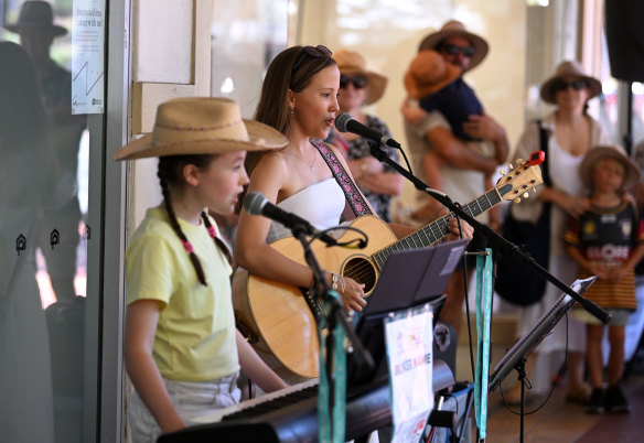 Sisters Tia (R) and Ellie Hannah busk as people celebrate Australia Day in Tamworth.