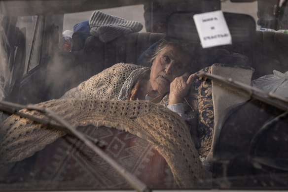 Varta, 81 of Mariupol, rests in the back of her family's car after a four-day journey to an evacuation point for people fleeing from Mariupol, in Zaporizhzhia, Ukraine.