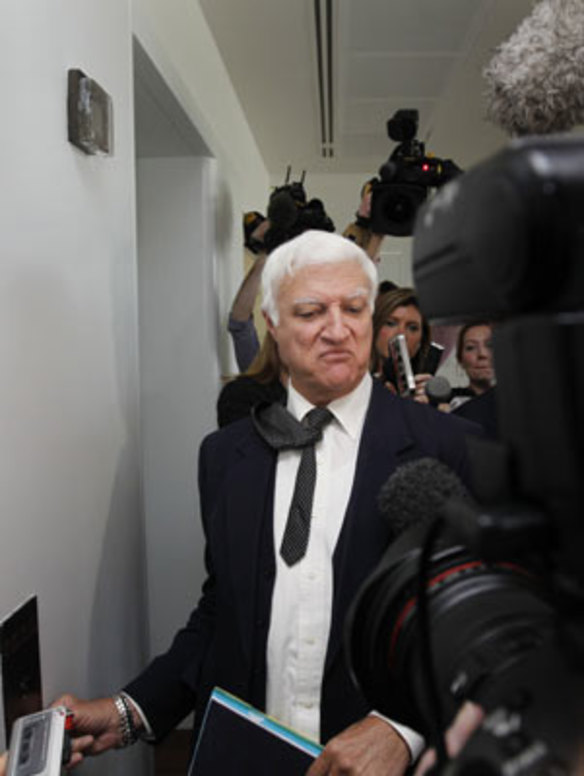 Independent Member for Kennedy Bob Katter gets questioned by representatives of the media after meeting with fellow Independents Tony Windsor and Robert Oakeshott at Parliament House in Canberra today .