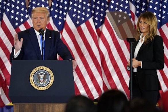 President Donald Trump speaks in the East Room of the White House in Washington, as first lady Melania Trump listens. Trump has thanked the millions of Americans who have voted for him, but he is clearly frustrated that he has not emerged the clear winner on election night.