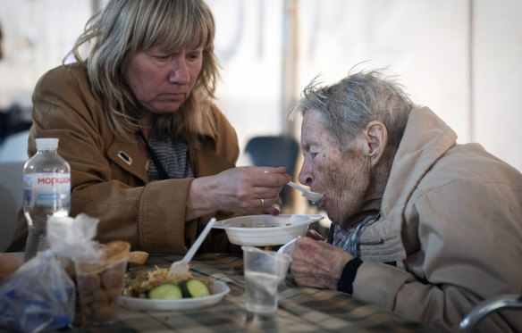 A man who was evacuated from the steel mill in Mariupol is given a warm meal. 