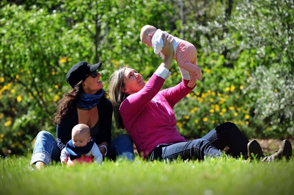 Canberra Capitals coach Carrie Graf, with partner Camille Chicheportische and baby twins Bentley (in blue ) and Charli (in red).