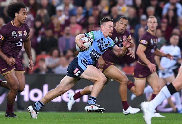Damien Cook of the Blues breaks the Maroons line.