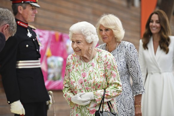 Britain's Queen Elizabeth II , centre, Camilla, the Duchess of Cornwall and Kate, the Duchess of Cambridge, attend an event in celebration of 'The Big Lunch 'initiative, during the G7 summit in Cornwall, England, Friday June 11, 2021. 