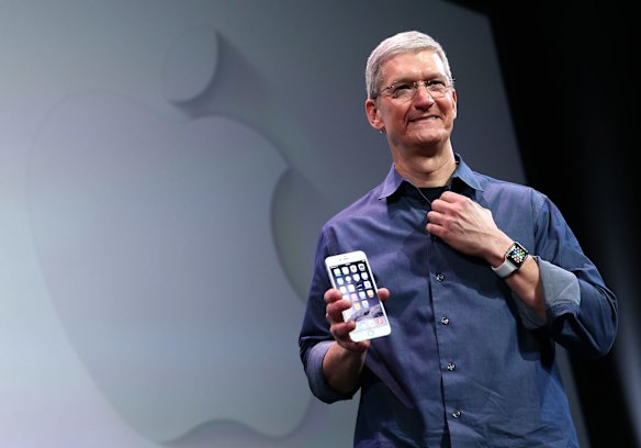 Apple CEO Tim Cook holds the new iPhone 6 Plus.