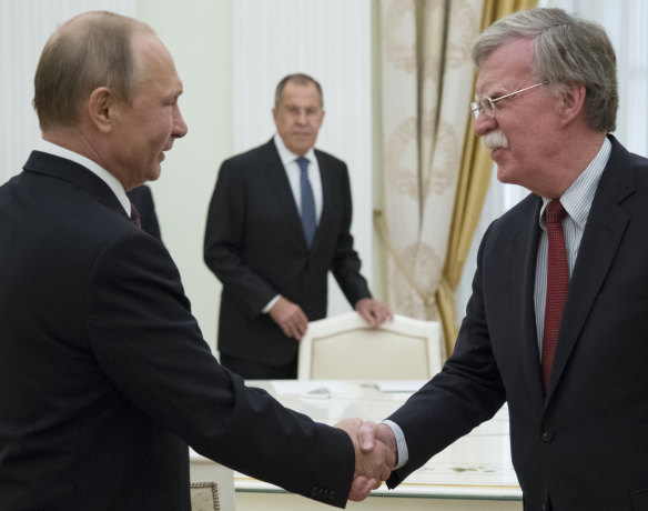 Vladimir Putin and U.S. National security adviser John Bolton greet each other in Moscow last week.