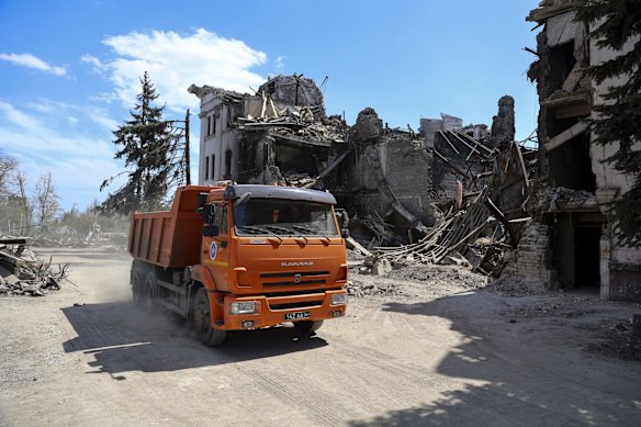 A truck drives past destroyed theatre damaged during fighting in Mariupol, in territory under the government of the Donetsk People's Republic. Municipal services have begun clearing rubble and cleaning the city. 