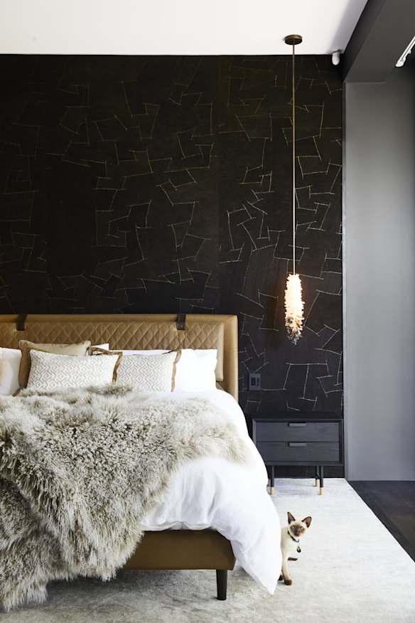 The master bedroom features a leather bed designed by Penny del Castillo and Arte bark wallpaper. The pendant light is by Christopher Boots.