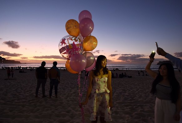 Erika Yin 25yrs celebrates her birthday as the sun rises over Bondi Beach, Sydney.