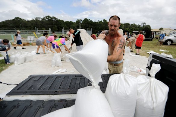 Ryan Kaye loads sandbags into his truck at a makeshift filling station provided by the county as protection ahead of Hurricane Irma, in Palm Coast, Florida.