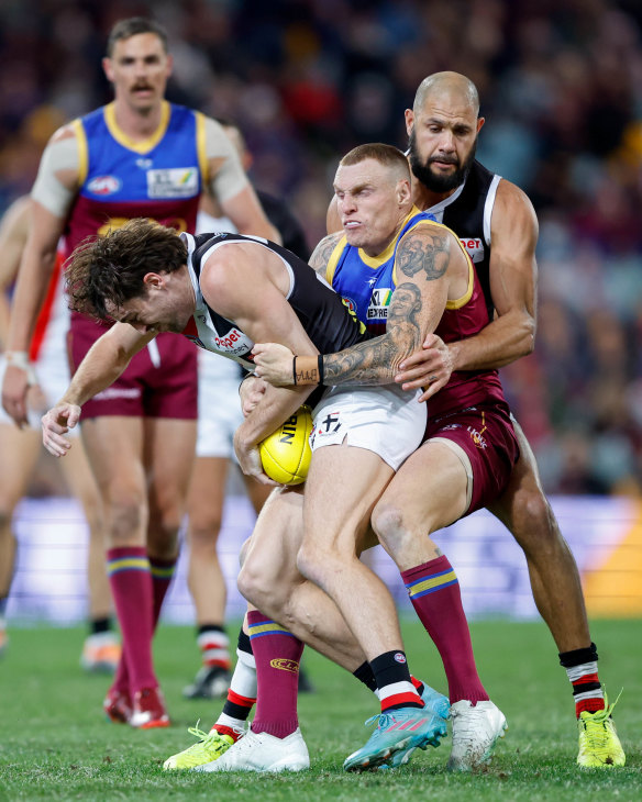 Ben Paton is tackled by Mitch Robinson.