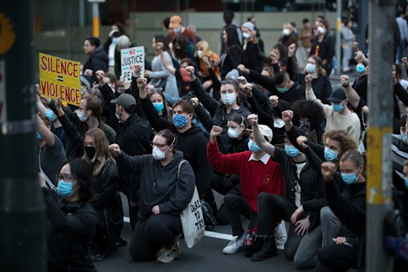 Protesters "take a knee" at the Black Lives Matter protest in Sydney against racism and police brutality.